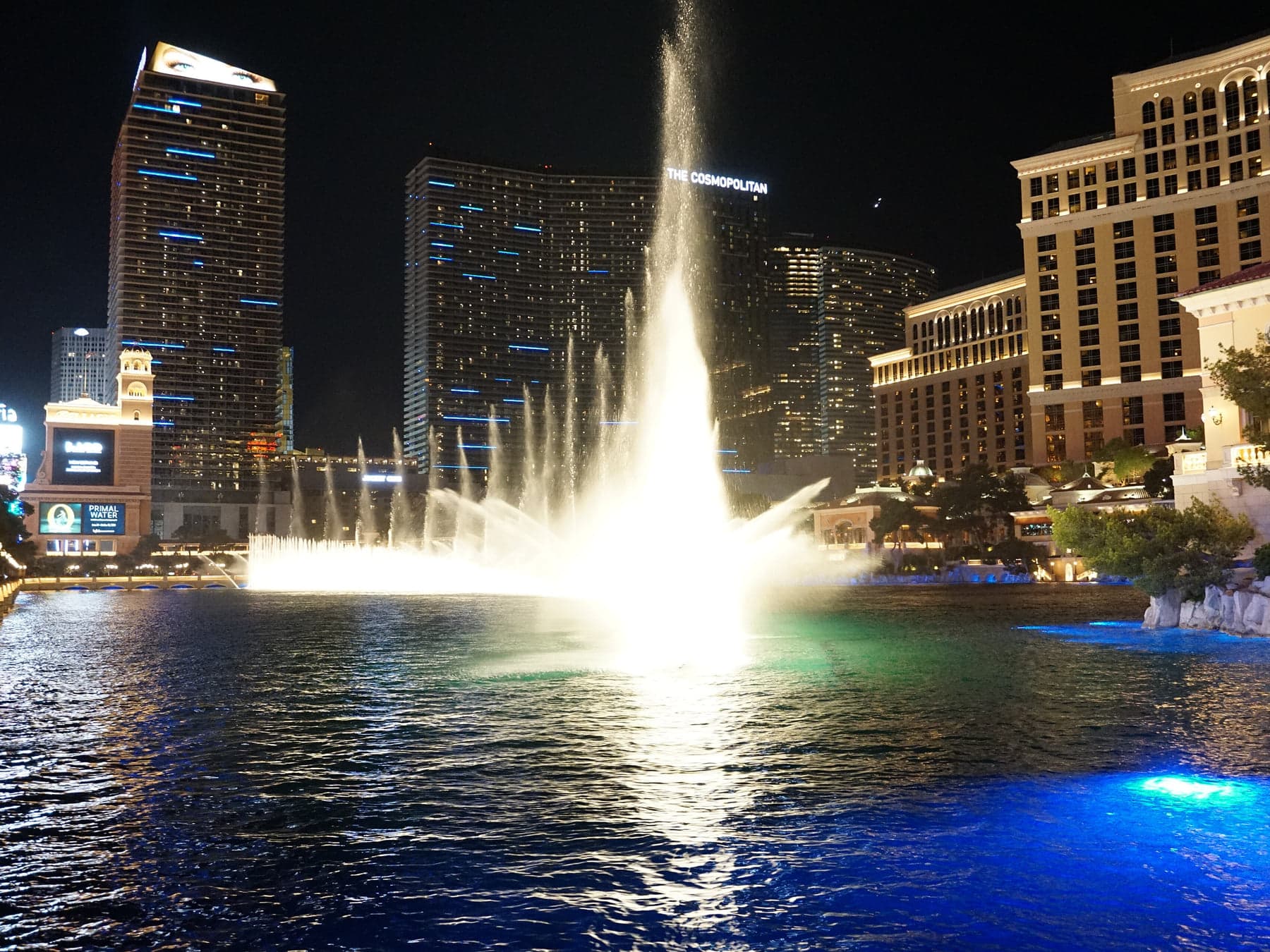 The Bellagio fountains firing at night.